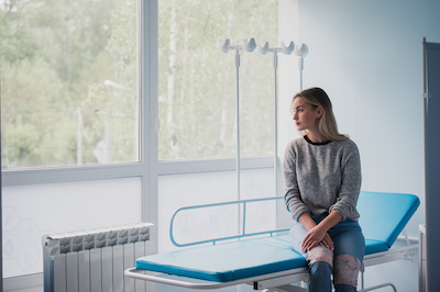 Female patient sitting in an exam room concerned about coronavirus | Tennessee Reproductive Medicine | Chattanooga, TN