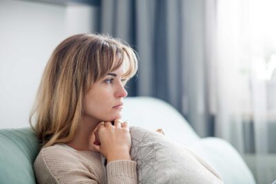 Woman sitting alone on sofa | TRM | Fertility Care in Chattanooga