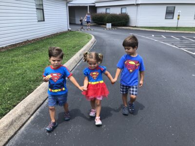 Five year old and three year old twins in superman costumes for our story on vanishing twin syndrome | Tennessee Reproductive Medicine | Chattanooga