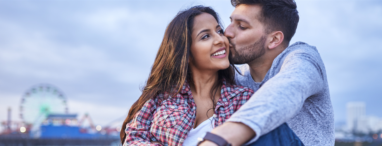 Couple kissing after receiving financial counseling for infertility treatment | Tennessee Reproductive Medicine | Chattanooga