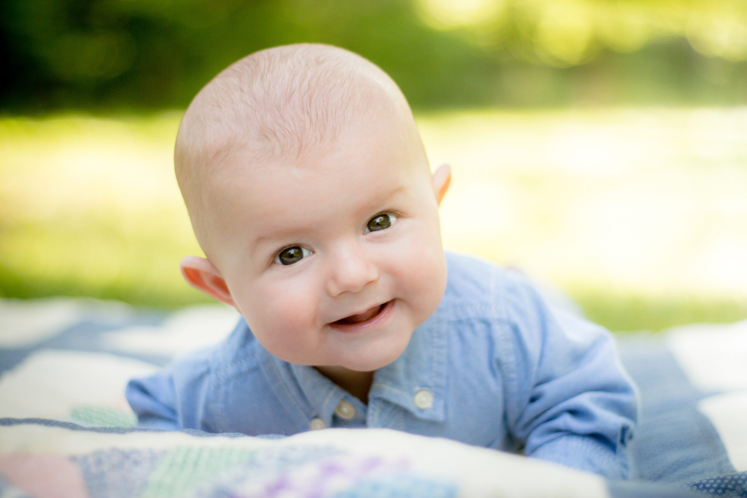 Smiling baby in blue who was born through IVF (in vitro fertilization) | Tennessee Reproductive Medicine | Chattanooga, TN