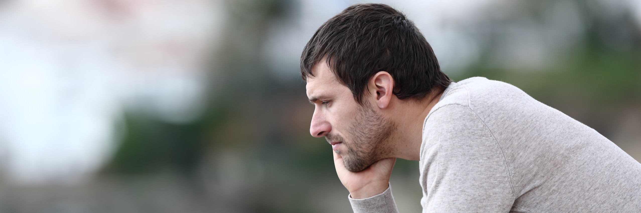 Man resting face on his hand thinking about needing male infertility treatments | TRM | Chattanooga, TN