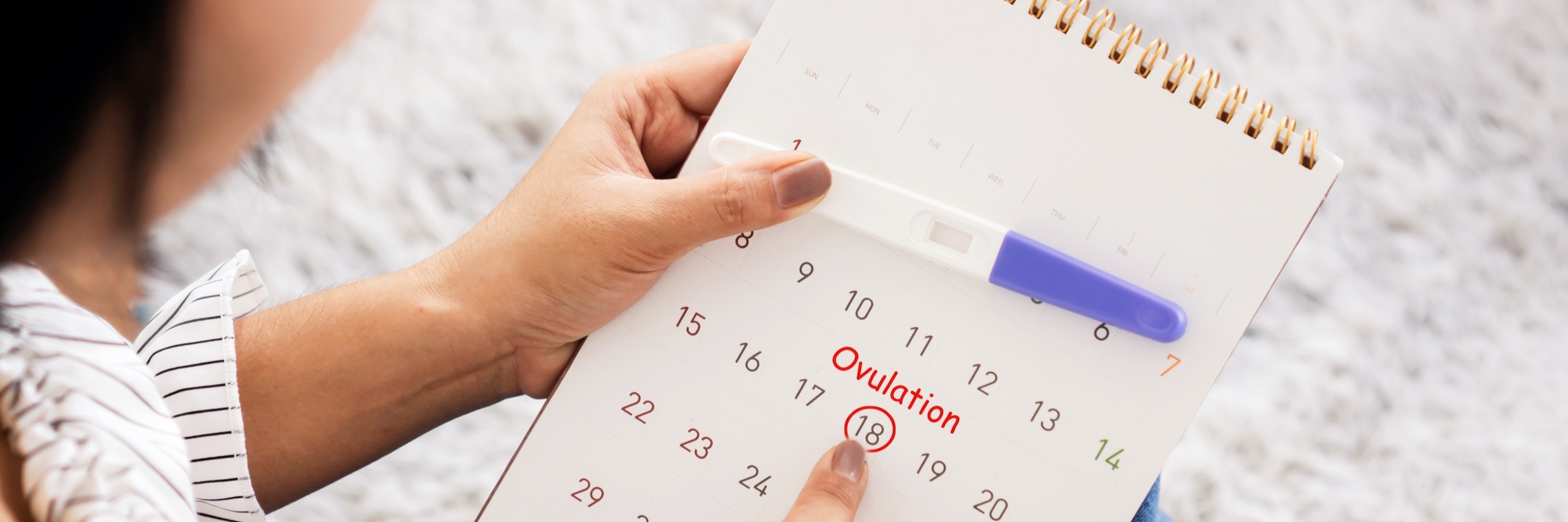 Woman marking calendar after ovulation testing with kit | TRM | Chattanooga, TN